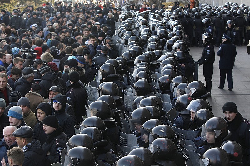 Ukrainian riot police block the entrance of the regional administrative building during a pro-Russian rally Sudnay in Donetsk, Ukraine.