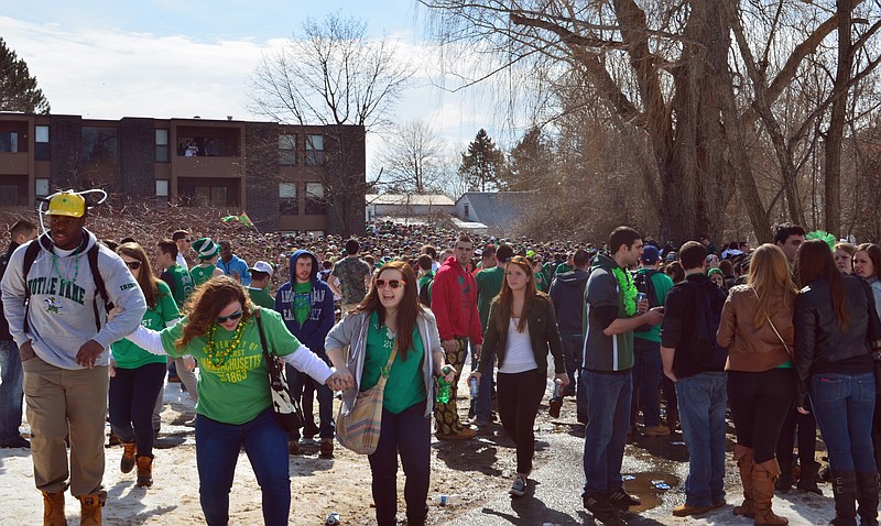 People gather for the pre-St. Patrick's Day "Blarney Blowout" near the University of Massachusetts in Amherst, Mass. on Saturday. Four police officers were hurt as they worked to disperse hundreds of unruly students who were throwing beer cans and bottles at police.