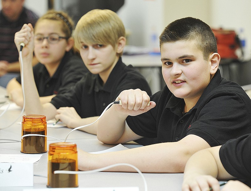Dalton Farris, at right, answers a question during Tuesday's Knowledge Bowl on the campus of Lincoln University. He and fellow sixth-grade Eugene Elementary School students Kelly Hoskins, second from left, and Morgan Brinker were among those competing in this year's Show-Me Conference Knowledge Bowl.