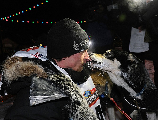 Dallas Seavey gets a kiss from one of his dogs on Tuesday after winning the 2014 Iditarod Trail Sled Dog Race in Nome, Alaska.