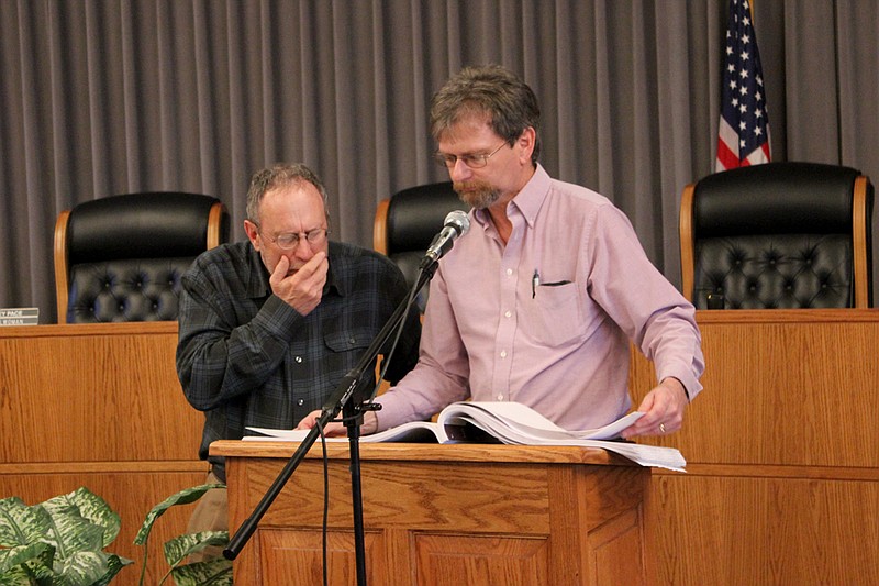 Jim Yancey, left, goes over sewer plant upgrade plans with Utilities Superintendent Darrell Dunlap at a town hall meeting Thursday. A former plant worker, Yancey dropped in toward the end of the meeting to view the changes resulting from an EPA mandate on effluence standards.