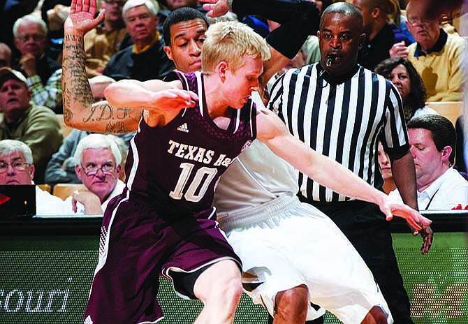 Texas A&M's Blake McDonald gets tangled up with Missouri's Jabari Brown as they vie for a loose ball during last Wednesday's game at Mizzou Arena. The two teams will meet again today at the SEC Tournament in Atlanta.