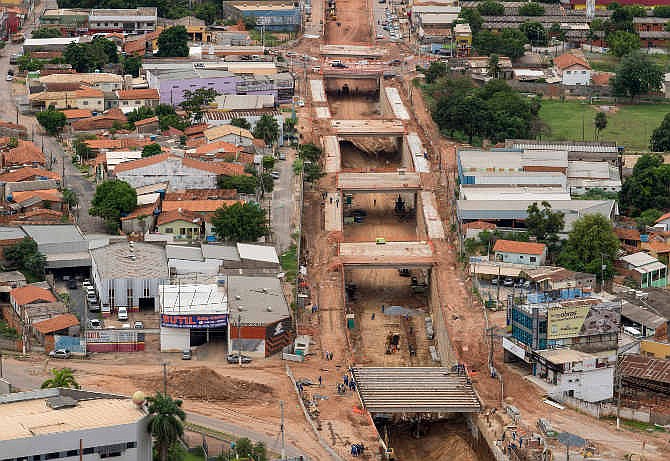 This Dec. 12, 2013 photo released by Portal da Copa, shows an aerial view of a project, known locally as "The Big Ditch," to reroute one of three main traffic arteries in Cuiaba, Brazil. It passes within a few hundred yards of the new stadium, and will hinder traffic getting to the stadium, not help it. Small business owners in the area say they were told two years ago when work began that it would be completed in a few months. They say they have lost money since then, and now can't get a straight answer as to when the work will be finished; certainly not in time for the World Cup. 