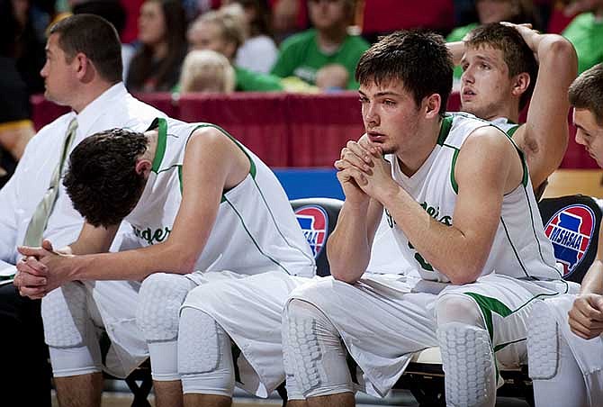 Iberia's Riley Hally, from left, Darrien Dickey and Dustin Bloodgood show their disappointment on the bench during the final minute of their 61-45 loss to Sacred Heart in the Class 2 Missouri State High School boys basketball championship game Saturday, March 15, 2014, in Columbia, Mo. The Rangers were ahead for most of the game until a Sacred Heart run in the fourth quarter.