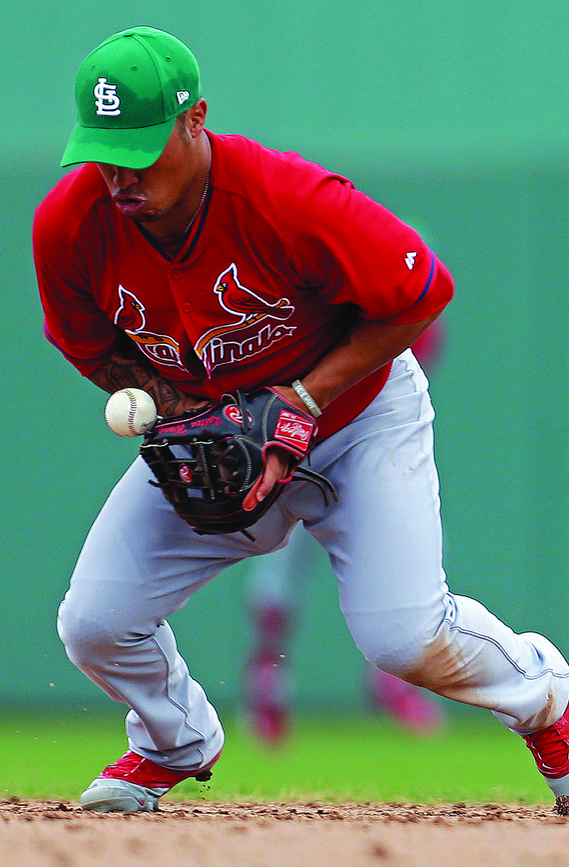 Cardinals second baseman Kolten Wong knocks down a ball during the fourth inning of Monday's game against the Red Sox in Fort Myers, Fla.