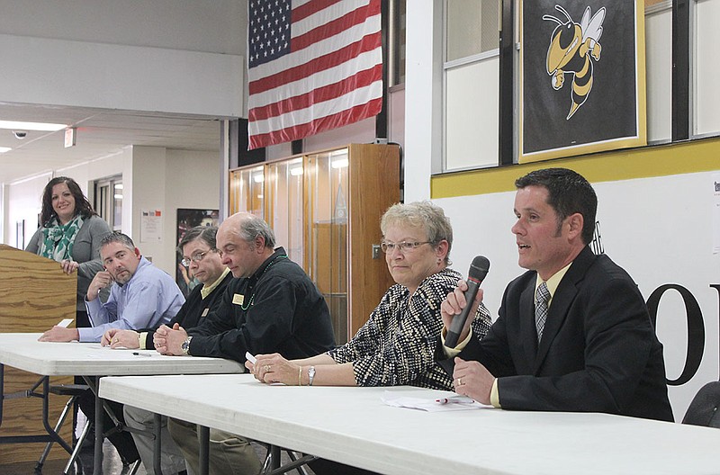 (Seated, from left) Fulton School Board candidates Scott King, David "Rob" Hunter, Kevin Habjan and Ruth Burt listen as fellow candidate Todd Gray introduces himself during a candidate forum at Fulton High School Monday afternoon. Hosted by the Fulton Community Teachers Association, the forum featured questions on topics such as Common Core Standards and teacher salaries.