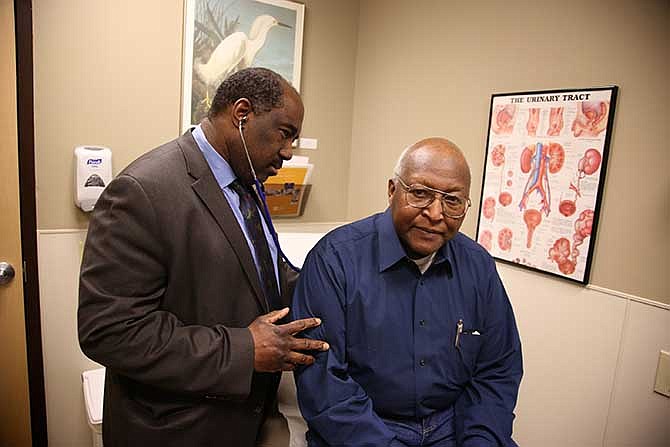 This photo taken Feb. 24, 2014, provided by the Roswell Park Cancer Institute, shows Dr. Willie Underwood, a urologic oncologist at Roswell Park Cancer Institute, examining patient Richard Waldrop at the Roswell Park Cancer Institute, in Buffalo, N.Y. 