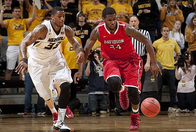 Missouri's Earnest Ross, left, and Davidson's De'Mon Brooks, right, chase down a loose ball during the first half of an NCAA college basketball game in the first round of the NIT, Tuesday, March 18, 2014, in Columbia, Mo.