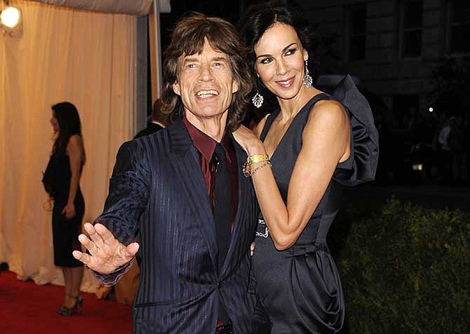 This May 7, 2012 file photo shows singer Mick Jagger, left, and L'Wren Scott at the Metropolitan Museum of Art Costume Institute gala benefit, celebrating Elsa Schiaparelli and Miuccia Prada, in New York. Scott, a fashion designer, was found dead Monday, March 17, 2014, in Manhattan of a possible suicide.