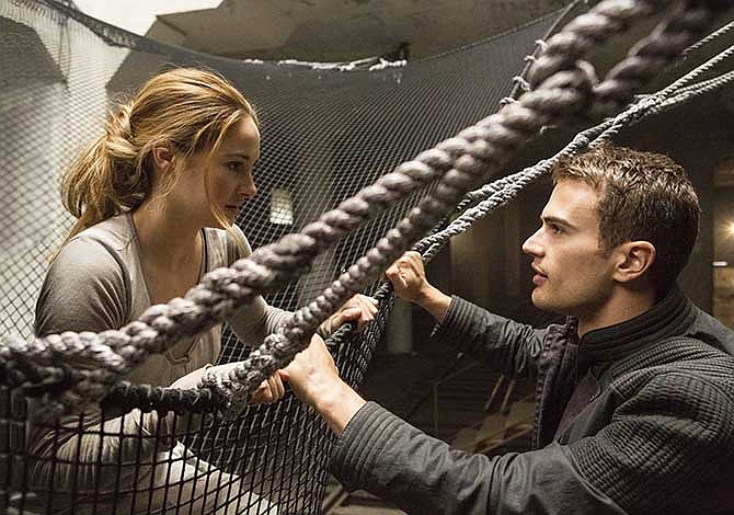 This image released by Summit Entertainment shows Shailene Woodley, left, and Theo James in a scene from "Divergent." The movie releases on Friday, March 21, 2014.