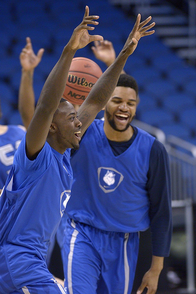 Saint Louis guard Mike McCall Jr. (left) celebrates after making a half-court basket during a practice for the NCAA Tournament on Wednesday in Orlando, Fla. Saint Louis will face North Carolina State in a second-round game today.