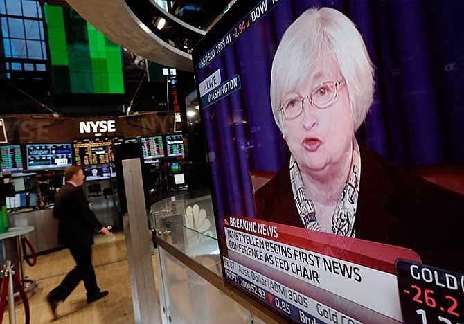 A television screen on the floor of the New York Stock Exchange shows Federal Reserve Chair Janet Yellen's first news conference, in Washington D.C., Wednesday, March 19, 2014. The Federal Reserve is seeking to clarify when it might start to raise short-term interest rates from record lows. The Fed also says it will cut its monthly long-term bond purchases by another $10 billion to $55 billion because it thinks the economy is strong enough to support further improvements in the job market. 