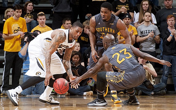 Missouri's Earnest Ross (left) loses control of the ball in front of Southern Mississippi's Jerrold Brooks (23) and Michael Craig during their NIT game Sunday in Columbia.