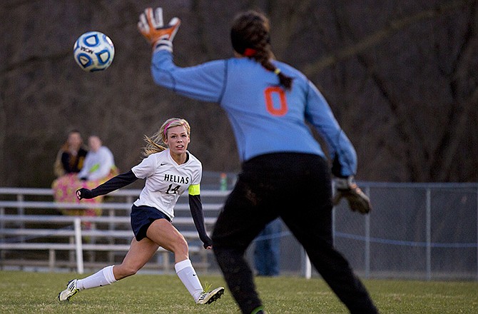 Helias midfielder Tiffany Weaver watches her shot fly past Waynesville goalie D'Anna Hasik for a goal during Tuesday night's game at the 179 Soccer Park.