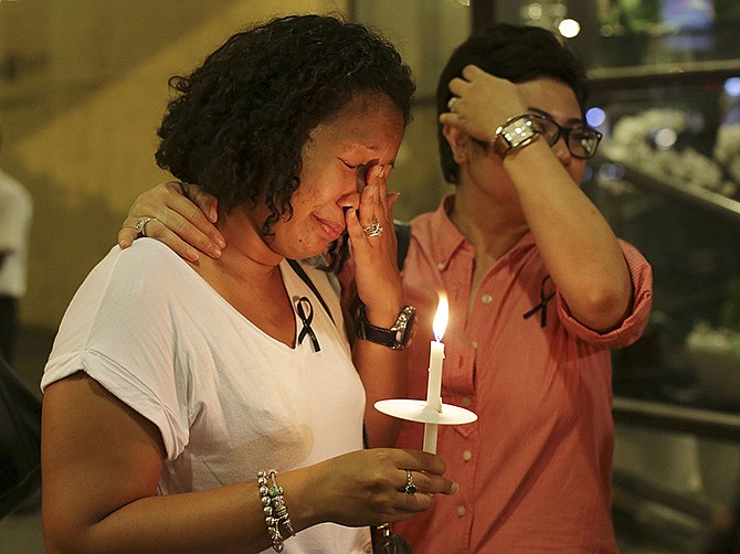 A woman wipes her tears as she joins a ceremony on Thursday in memory of passengers on board the missing Malaysia Airlines Flight MH370 in Kuala Lumpur, Malaysia. 