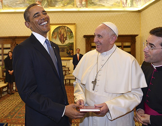Pope Francis and President Barack Obama smile as they exchange gifts at the Vatican Thursday. Their historic first meeting comes as Obama's administration and the church remain deeply split on issues of abortion and contraception.