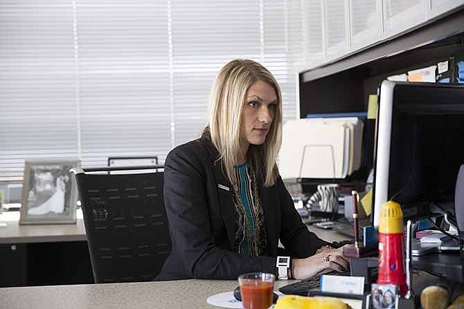 This March 26, 2014 photo shows Nida Degesys, National President of the American Medical Student Association, at her office in Sterling, Va. Degesys graduated in May 2013 from Northeast Ohio Medical University with about $180,000 in loans. The amount has already swelled with interest to about $220,000. Yet, as costly as medical school was, Degesys sees it as an investment in herself and her career, one she thinks will pay off with a higher earning potential. 