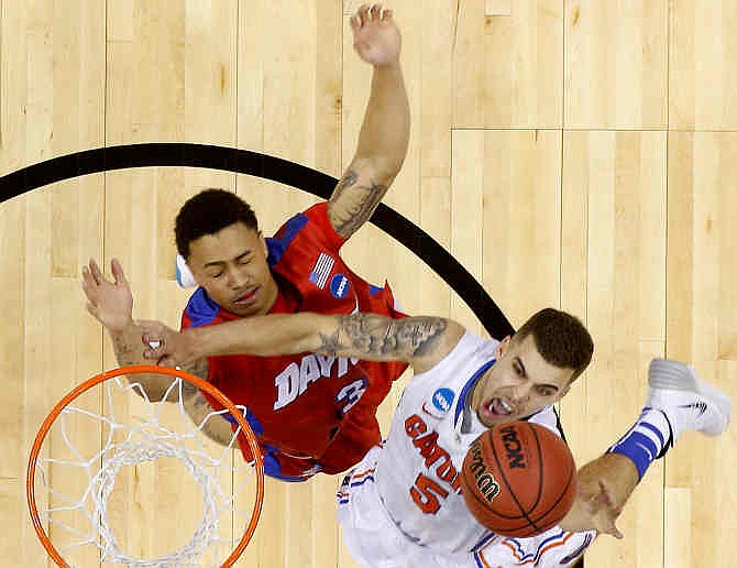 Florida guard Scottie Wilbekin (5) shoots over Dayton guard Kyle Davis (3) during the first half in a regional final game at the NCAA college basketball tournament, Saturday, March 29, 2014, in Memphis, Tenn. 