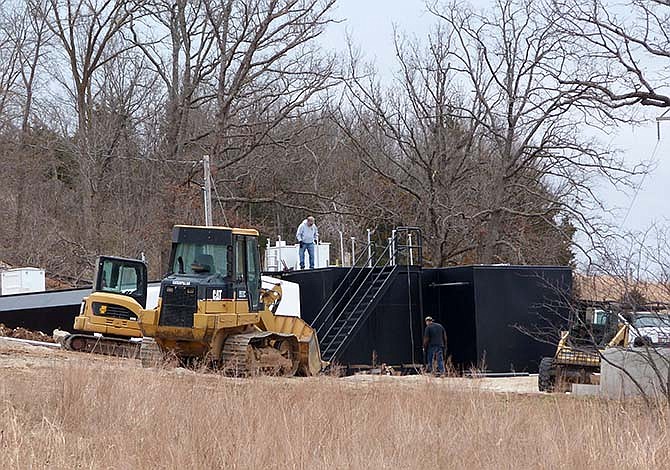 Workers install a sewage treatment plant along Missouri Highway 5 in Sunrise Beach, Mo. Installation of the treatment system along with more than a mile of sewer mains is the first step in bringing citywide sewer service to the town.