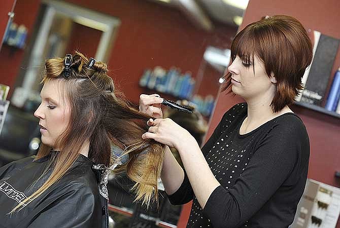 Stylist Jenni Hagerman uses the OmbrÃ© coloring technique to add blonde streaks to Shae Murphy's hair. Hagerman owns Cheveaux Salon in Hyde Park in Jefferson City.