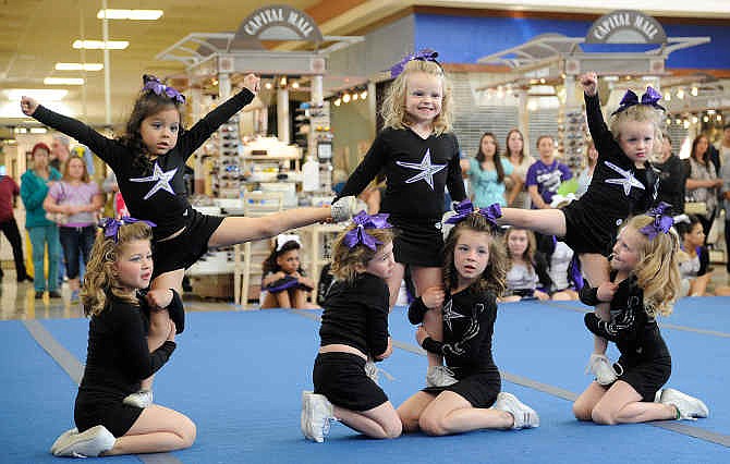 Members of the Youth Prep team Brilee Ash, Anna Todd, Madison Hancock, Kaylee Hargis, Dakota Johnson, Shyla Marcum and Emma Doden perform their routine Sunday during Capitol City Cheer's second annual showcase at Capital Mall.