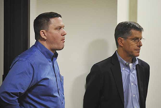 Officials with the Ehrhardt Hospitality Group, including Scott Ehrhardt, left, listen to comments at a public hearing on two conference center proposals last week at Jefferson City Hall.