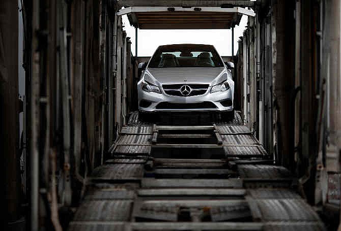 In this March 27, 2014 picture, a Mercedes-Benz vehicle sits inside a car-carrier before being hauled away for distribution from the company's Vehicle Processing Center in Baltimore. 