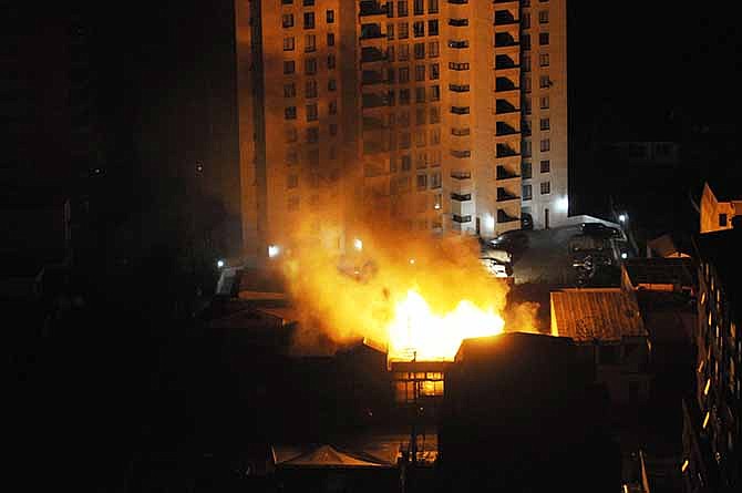 A fire burns at a restaurant after an earthquake in Iquique, Chile, Tuesday, April 1, 2014. A powerful magnitude-8.2 earthquake struck off Chile's northern coast Tuesday night.