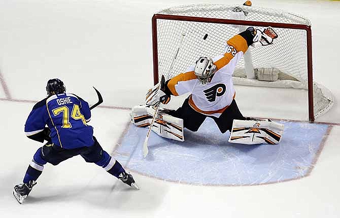 St. Louis Blues' T.J. Oshie (74) scores past Philadelphia Flyers goalie Ray Emery during a shootout of an NHL hockey game Tuesday, April 1, 2014, in St. Louis. The Blues won 1-0. 