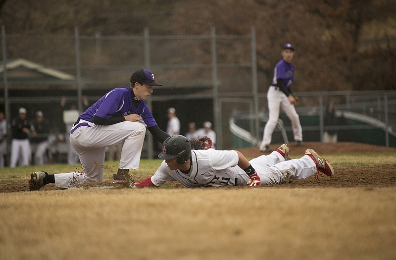 Jefferson City's Hayden Strobel dives back into first on a pickoff attempt during Tuesday's game against Pacific at Vivion Field.