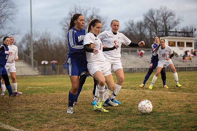 Jefferson City players Natalie Vance (3) and Tayler LePage (5) try to control the ball while closing in on the Moberly goal Tuesday night at the 179 Soccer Park.