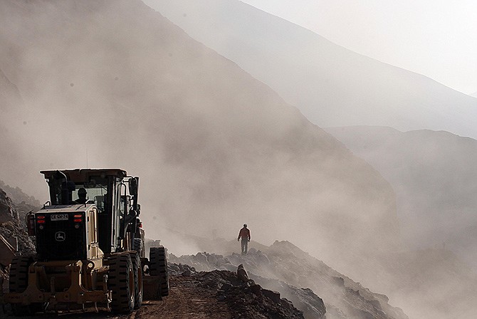 Heavy machinery is used in the clearing of debris Thursday on the road leading to the town of Camarones, in Arica. The road was cut off due to the magnitude-8.2 quake that struck Chile's Northern coast on Tuesday. Authorities discovered surprisingly light damage from the quake. 