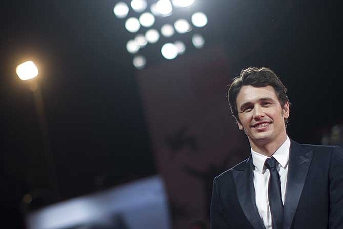 In this Aug. 31, 2013 file photo, actor and director James Franco poses for photographers on the red carpet for the screening of the film "Child Of God" at the 70th edition of the Venice Film Festival in Venice, Italy.