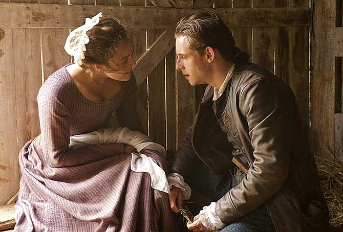 This image released by AMC shows Heather Lind as Anna Strong, left, and Jamie Bell as Abe Woodhull in a scene from "Turn," premiering Sunday at 9 p.m. EDT. 