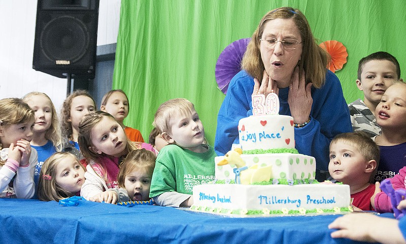 Surrounded by her students, Millersburg Preschool Founder Sherri Griffin blows out the candles on a celebratory cake Saturday. Preschool students, alumni, parents and community members came together to celebrate the school's 30 years in operation and honor its founder, Griffin. She said teaching at the preschool has been her "greatest joy."