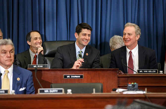 House Budget Committee Chairman Rep. Paul Ryan, R-Wis., presides over a markup session where House Republicans are are pressing ahead with a slashing plan to try to balance the budget within 10 years, relying on big decreases in health care programs for the middle class and the poor, as well as tax hikes and Medicare cuts engineered by President Barack Obama. Ryan is flanked by Rep. Chris Van Hollen, D-Md., right, the ranking member, and Rep. Roger Williams, R-Texas, lower left. 