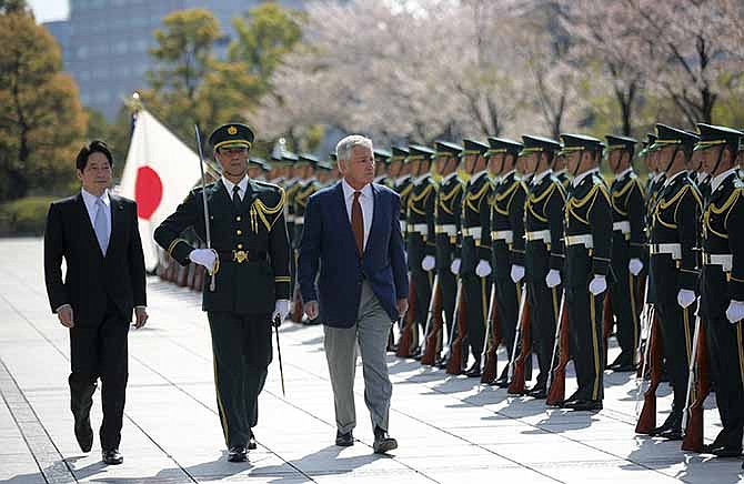 U.S. Secretary of Defense Chuck Hagel, right, and Japanese Defense Minister Itsunori Onodera, left, inspect an honor guard at the Defense Ministry in Tokyo, Sunday, April 6, 2014. Against the backdrop of Russia's takeover of Ukraine's Crimean region, Hagel said Saturday he will convey to Japanese leaders that the U.S. is strongly committed to protecting their country's security. 