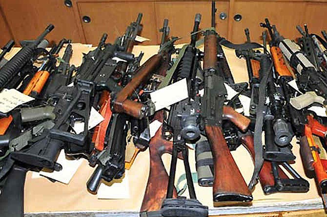 This image released by the Fresno County Sheriff via KMPH-TV shows guns seized from Christopher Haga, who was arrested is Sept. 2011 after police found this stash of assault rifles. Haga reportedly offered legal help from the National Rifle Association. The NRA has taken on California and other states over their strict requirements on who can carry concealed weapons and cities like San Francisco over their bans of high-capacity magazines. Their multi-million legal campaign has had mixed success so far, but the NRA appeals its losses, publicizes its wins and decides where to fight next.