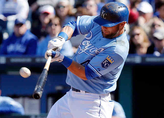 Kansas City Royals' Alex Gordon hits a double during the eighth inning of a baseball game against the Chicago White Sox at Kauffman Stadium in Kansas City, Mo., Saturday, April 5, 2014. Gordon scored the go-ahead run later in the inning. The Royals won 4-3.