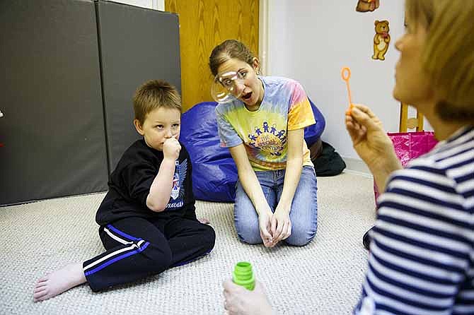 Mary Beth Hoey, right, blows bubbles for Maddox Brewer, left, a student at the Special Learning Center, where Hoey is an Early Childhood Special Education Teacher. Hoey and speech pathologist Courtney Gragg were working with Brewer while also teaching him words.