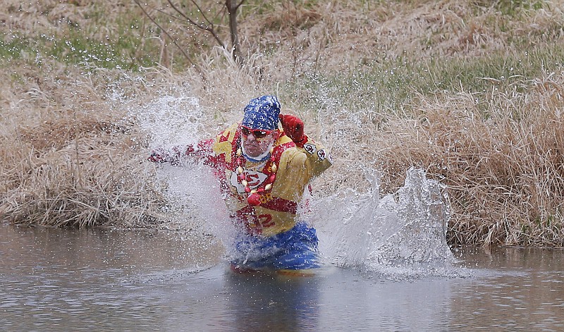 Kansas City Chiefs fan Ty Rowton takes a Plunge for Landon in a farm pond near Bonner Springs, Kan. A 5-month-old boy's battle with cancer has inspired hundreds to jump into cold bodies of water, from a local golf course pond to the Gulf of Mexico and even the Potomac River in Washington, D.C.