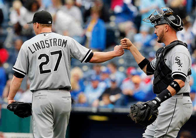Chicago White Sox relief pitcher Matt Lindstrom (27) and catcher Tyler Flowers, right, fist bump following a baseball game against the Kansas City Royals at Kauffman Stadium in Kansas City, Mo., Sunday, April 6, 2014. The White Sox won 5-1. 