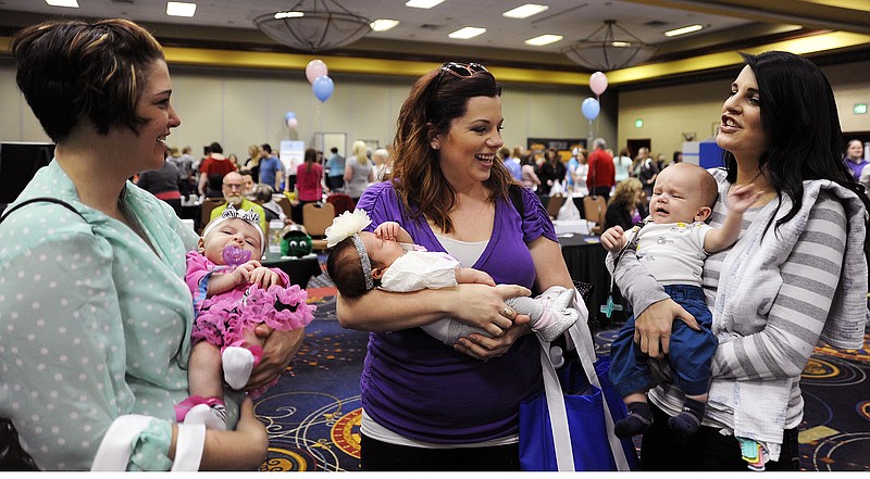 FILE: From left, moms Misty Byland, Erin Risse and Lucy Best chat at the 3rd annual Baby Bonanza at Capitol Plaza Hotel with their respective babies: Ava, 2 months; Henley, 1 month; and Cash, 3 months. The Jefferson City women are friends and first-time mothers.