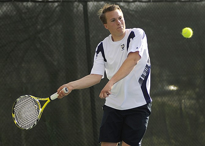 Helias' Jeremy Wolters steps up to smash a forehand return across the net during Monday's boys tennis matchup against Hickman at Washington Park. 