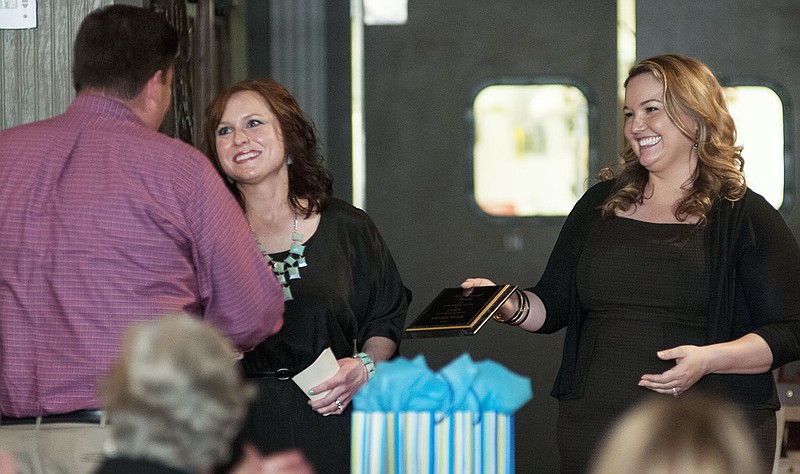 Erica Nanney, director of the Callaway County Center Against Rape and Domestic Violence (CARDV), and the organization's incoming president, Kasi Lacey, present Matthew Palmer, domestic violence investigator for Callaway County, the Kate Conniff award Tuesday during CARDV's 20th anniversary celebration.