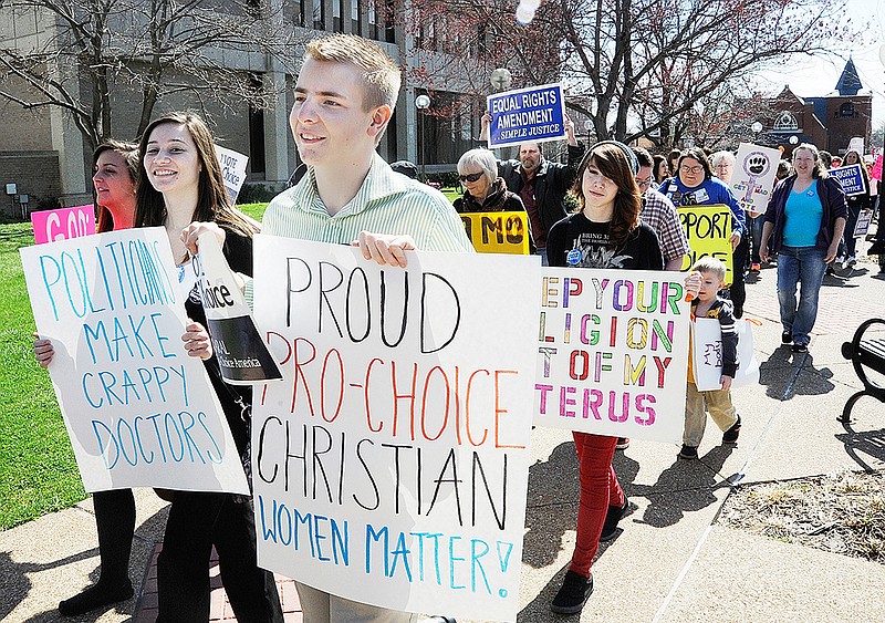 Several hundred people attending Tuesday's Equal Rights Action Day rally walked from the Missouri River Regional Library on High Street to the Capitol before rallying in support of women's issues.