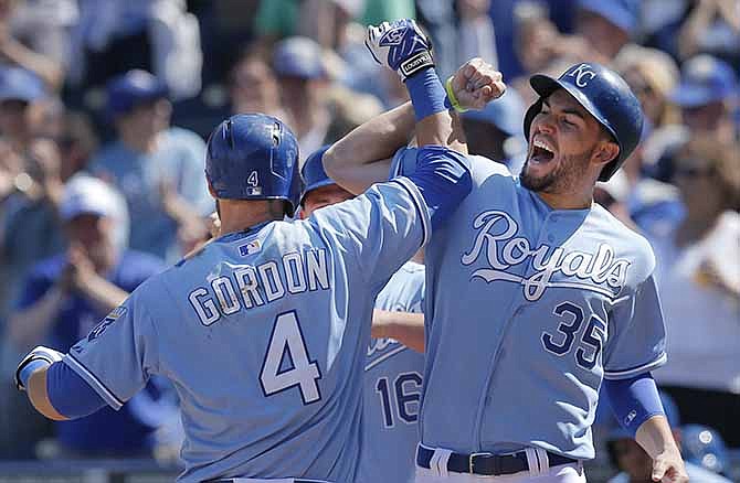 Kansas City Royals' Alex Gordon (4) is congratulated by teammate Eric Hosmer (35) after his three-run home run during the fifth inning of a baseball game against the Tampa Bay Rays at Kauffman Stadium in Kansas City, Mo., Wednesday, April 9, 2014.