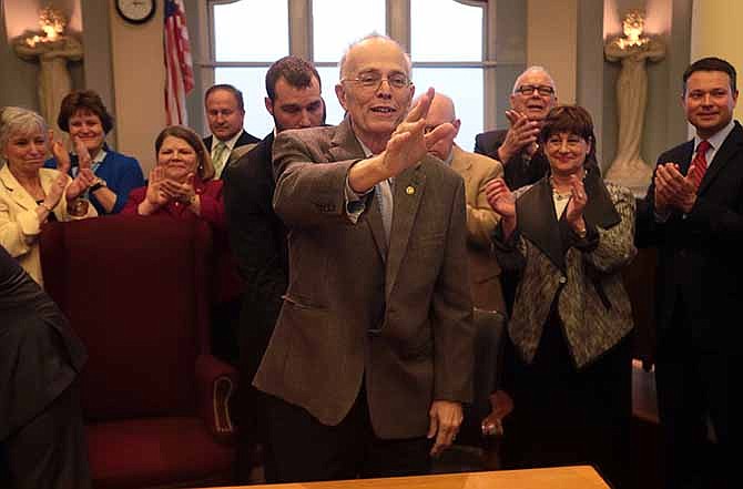 After being wheeled in, State Representative Rory Ellinger stands to acknowledge the room full of friends and colleagues who came to watch the signing of Missouri House Bill 1320 - which protects the rights of nursing mothers - on April 3, 2014, at University City Hall. Ellinger died Wednesday, April 9, 2014 following a battle with liver cancer, colleagues said. He was 72.