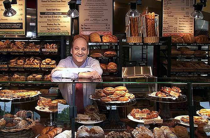 In this May, 2002 file photo Panera Bread Co. CEO Ron Shaich stands behind a counter at a location in St. Louis. The chain is planning to overhaul its "mosh pit" ordering system at its roughly 1,500 locations nationwide in a project called Panera 2.0.
