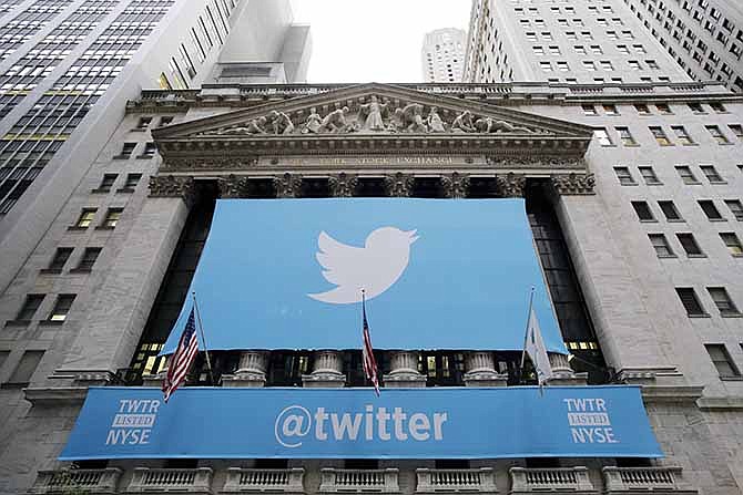 In this Thursday, Nov. 7, 2013 file photo, a banner with the Twitter logo hangs on the facade of the New York Stock Exchange in New York the day after the company went public.